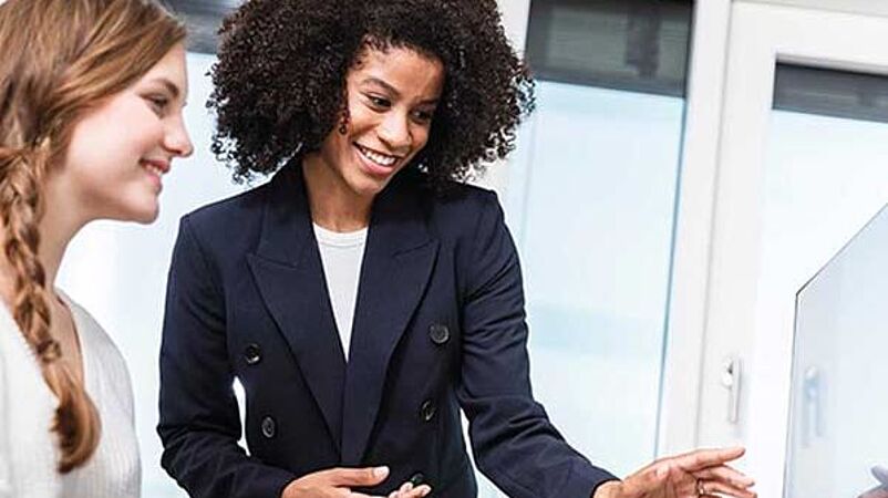Apparel engineer and designer look at a screen